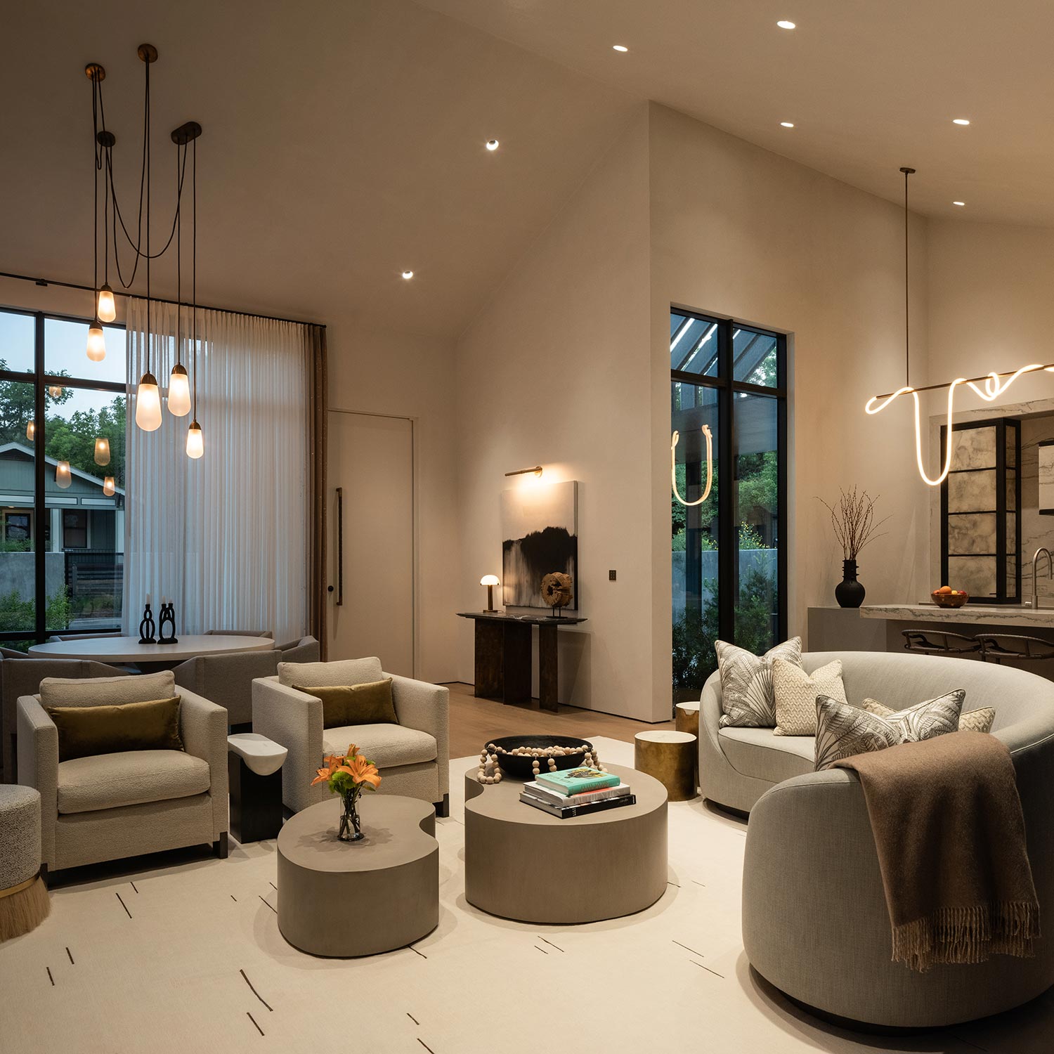 modern living room with soft seating round tables and warm pendant lighting