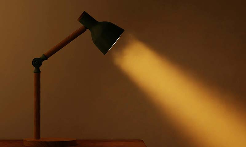 a black lamp turned on shining through foggy air