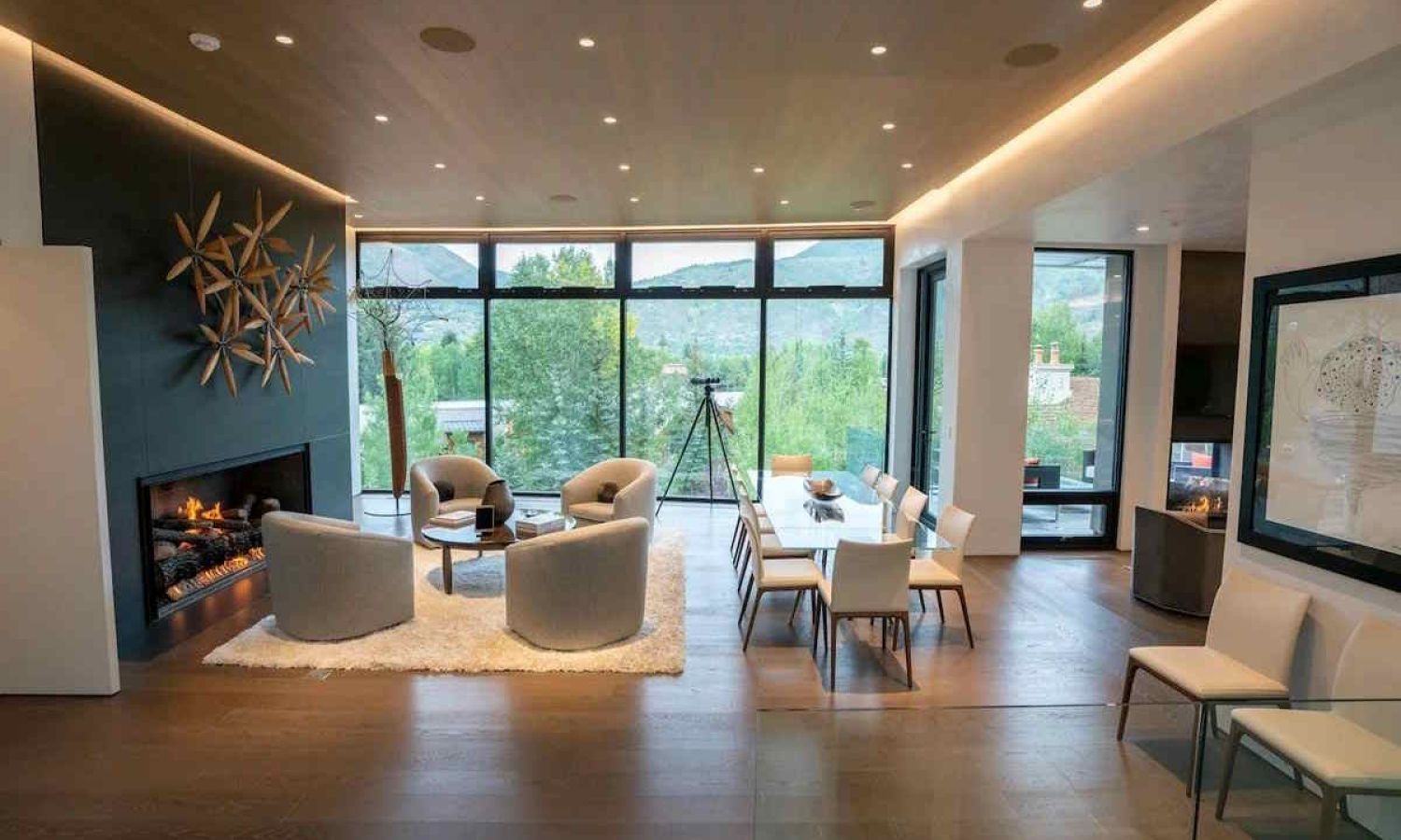 Modern living room with fireplace and speakers integrated into the wooden ceiling
